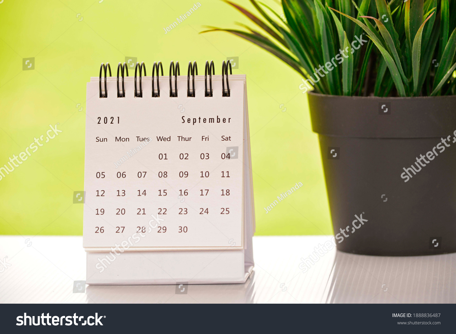 White September 2021 calendar with green backgrounds and potted plant. 2021 New Year Concept #1888836487
