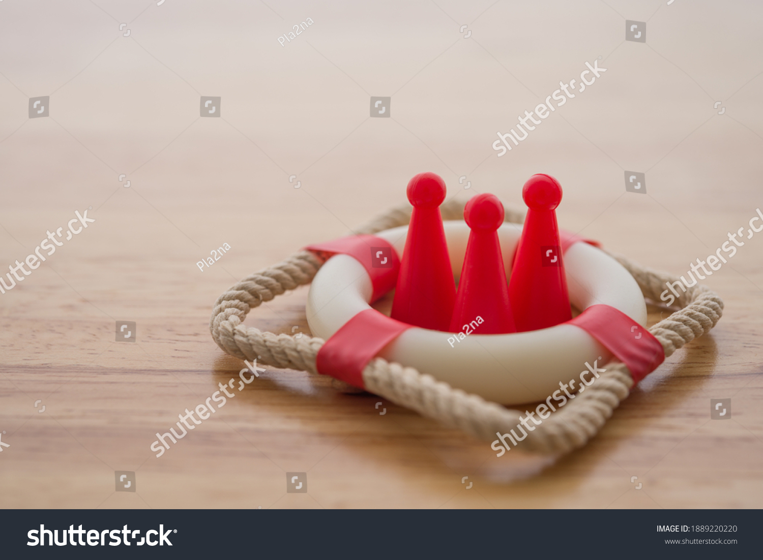 Health insurance or life insurance business and health care concept. People model in lifebuoy on wooden table background copy space. #1889220220