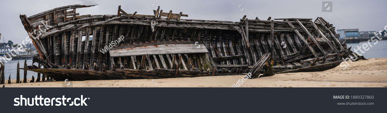 Stranded fishing boats on the beach. Historical wreck in France. #1889327860