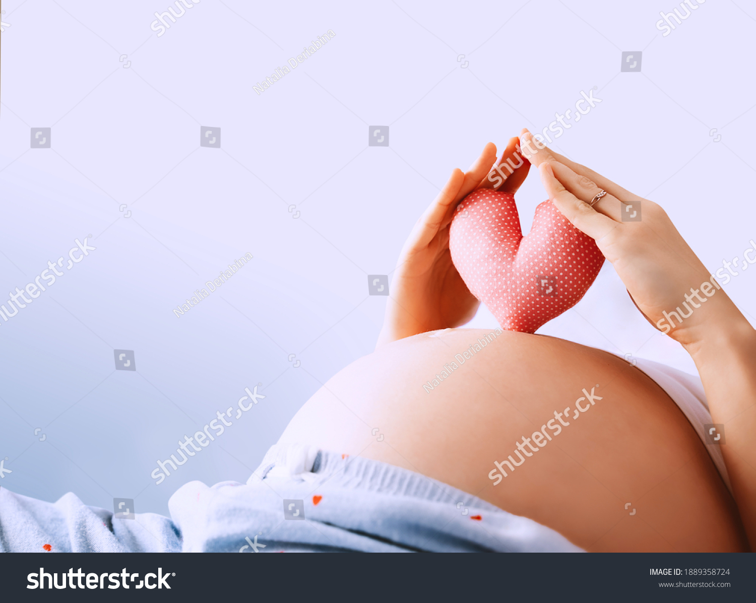 Pregnant woman holds in palms symbol in heart shape. Loving mom waiting of a baby. Concept of maternity, parenting, prepare and expect. Happy expectant mother during pregnancy. #1889358724