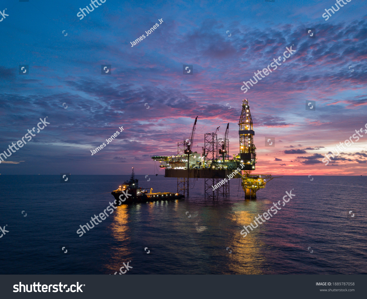 Aerial view offshore drilling rig (jack up rig) at the offshore location during sunset #1889787058