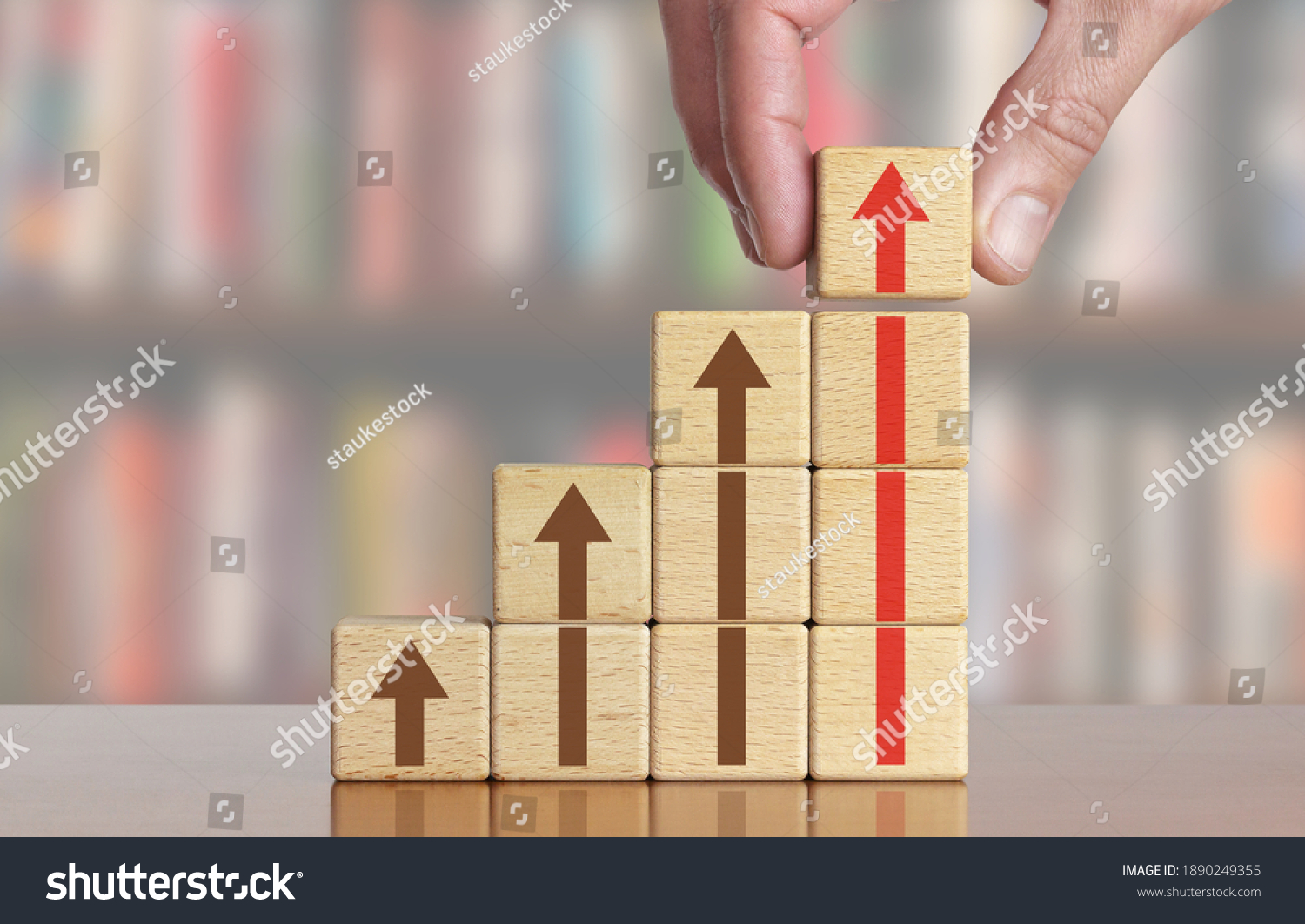 Hand arranging wood block stacking as step stair with arrow up. Ladder career path concept for business growth success process  #1890249355