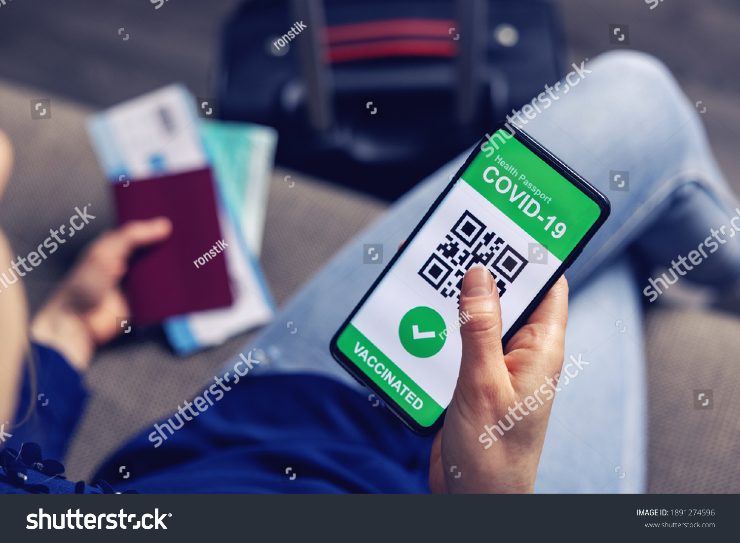 vaccinated person using digital health passport app in mobile phone for travel during covid-19 pandemic. green certificate #1891274596