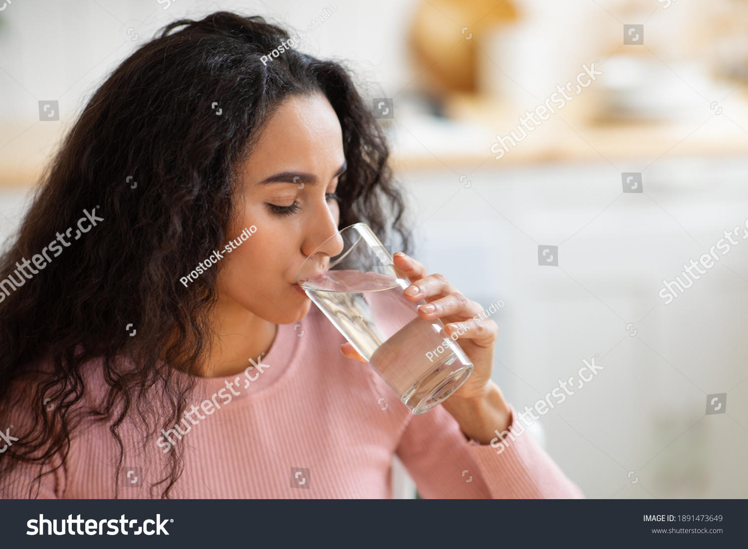 Healthy Liquid. Beautiful Brunette Woman Drinking Mineral Water From Glass In Kitchen, Thirsty Young Lady Enjoying Refreshing Drink At Home, Closeup Portrait With Selective Focus, Free Space #1891473649