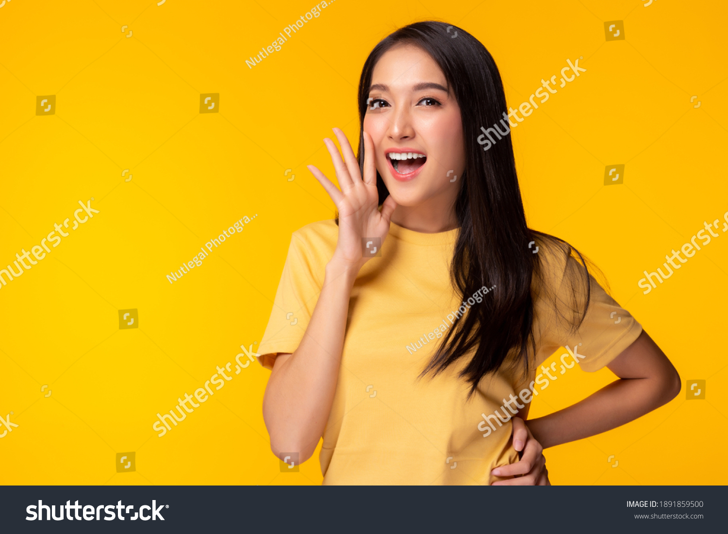 Surprised happy beauty asian woman look at camera in excitement Expressive facial expressions Presenting some product Beautiful girl act like a telling something Isolated on yellow background  #1891859500