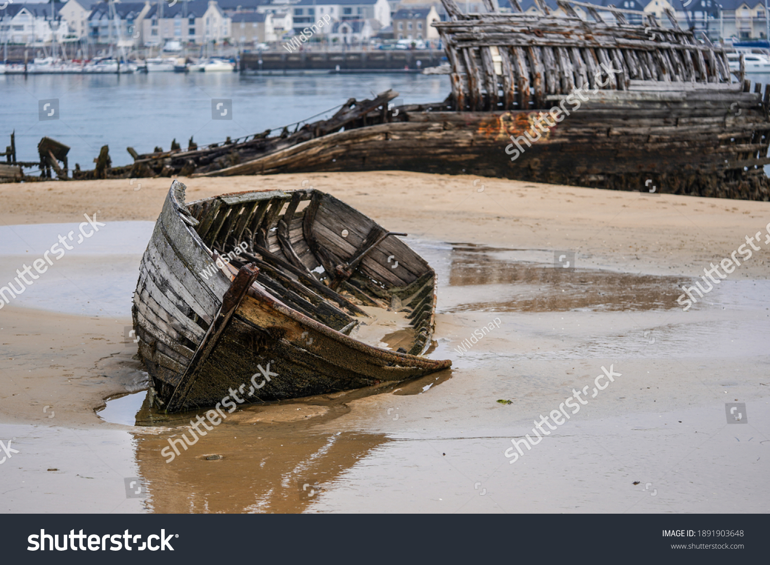 Stranded fishing boats on the beach. Historical wreck in France. #1891903648