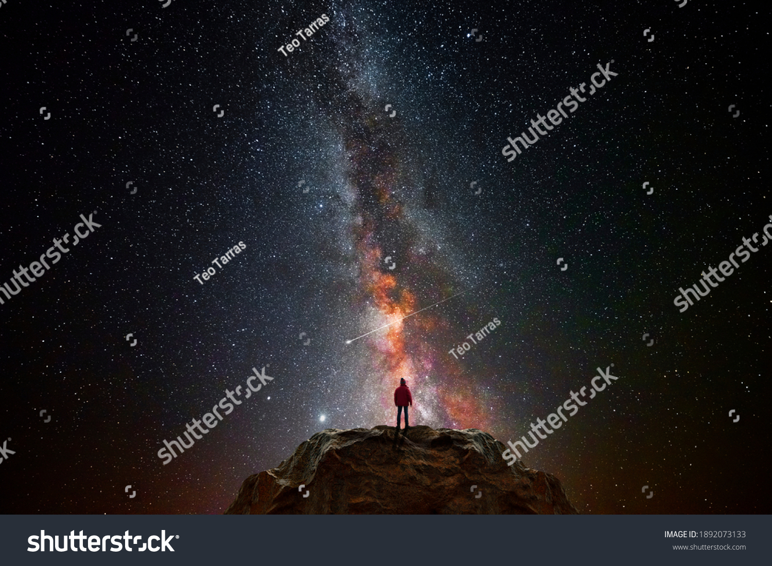 Man on top of a mountain observing the universe #1892073133