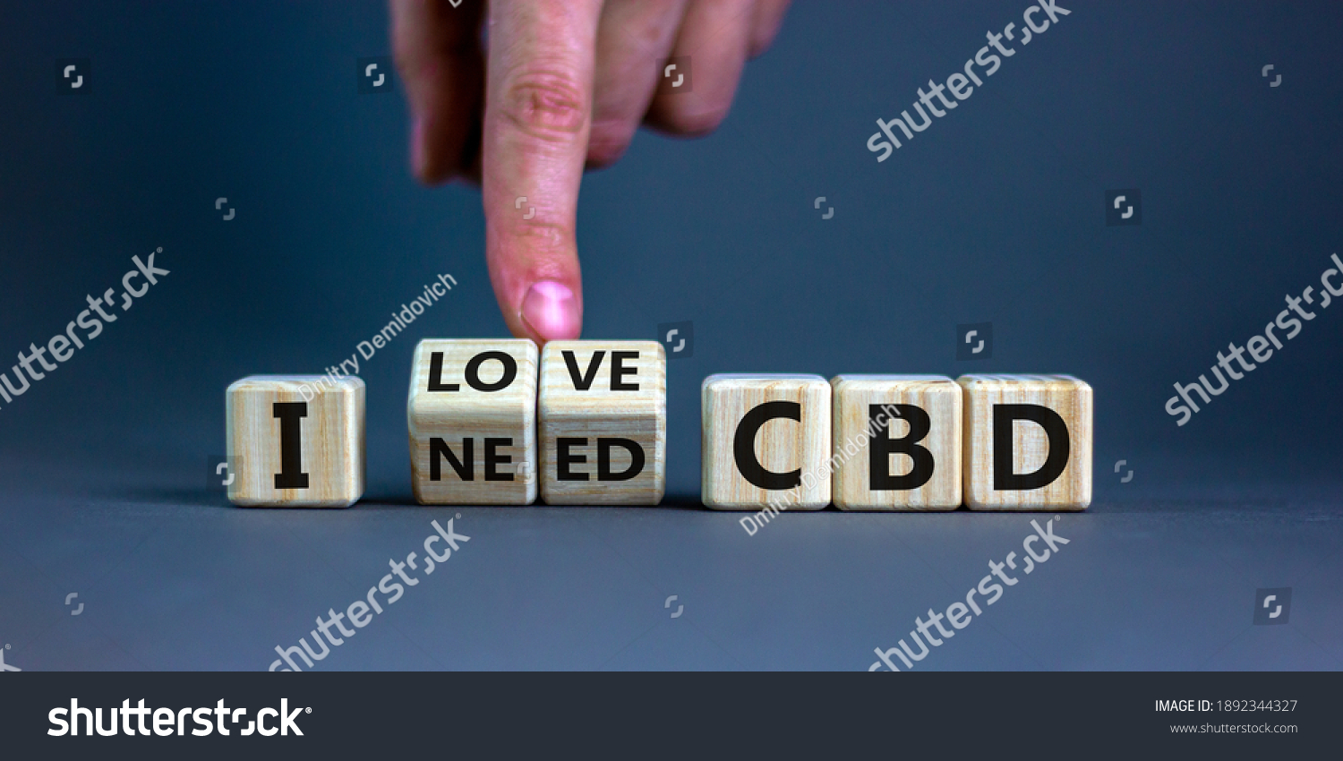 I love CBD, cannabidiol symbol. Hand turns cubes and changes words 'I need CBD' to 'I love CBD'. Beautiful grey background, copy space. Medical and i love CBD cannabidiol concept. #1892344327