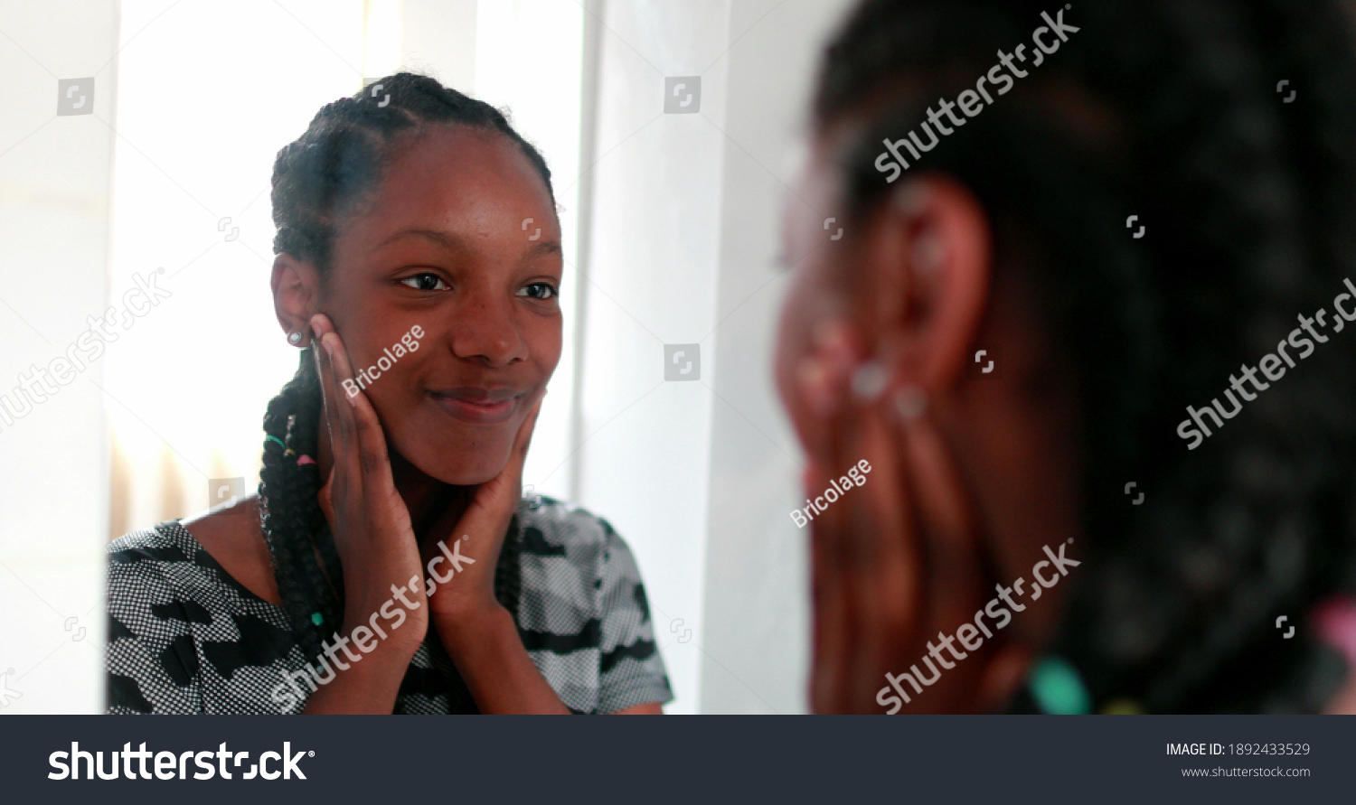 Confident teen adolescent black girl looking herself at mirror #1892433529