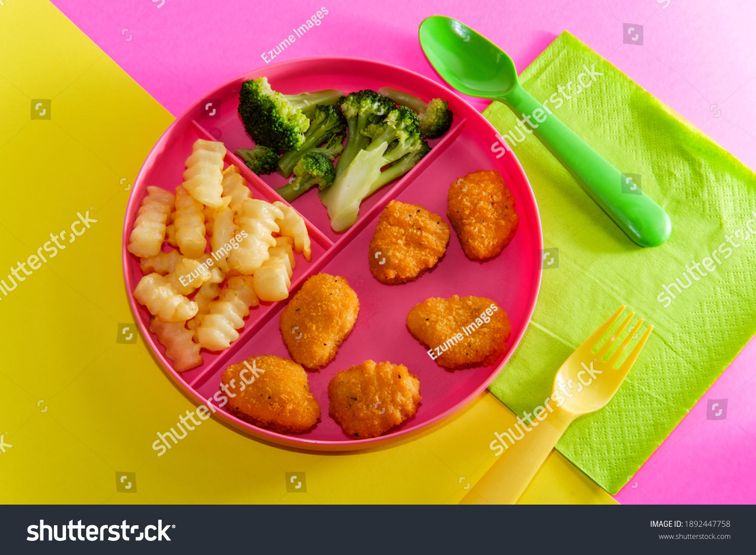 At home schooling chicken nugget lunch served on tray with french fries and broccoli #1892447758