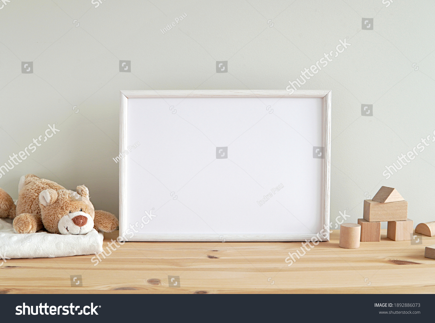Blank horizontal frame mockup, nursery framed wall art, baby room art, empty frame for print, photo, wooden shelf, baby toys and blanket.   #1892886073