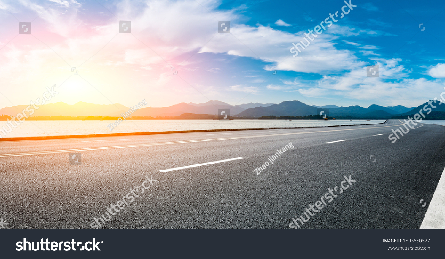 Asphalt road and mountain with sky clouds at sunset. #1893650827