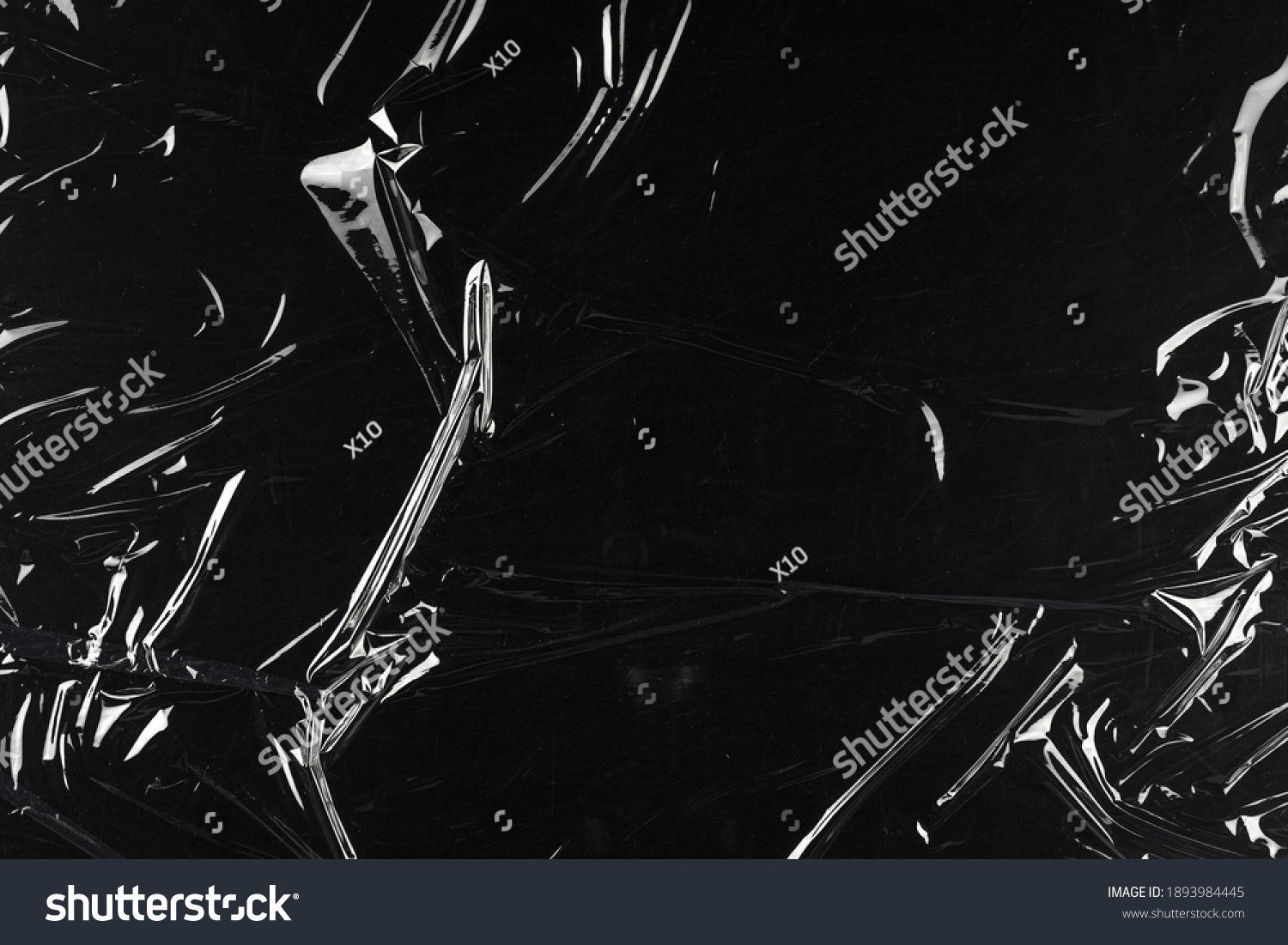 Transparent plastic wrap on the black background. Clean blank texture overlay effect template. Isolated wrinkle surface branding mock-up. #1893984445