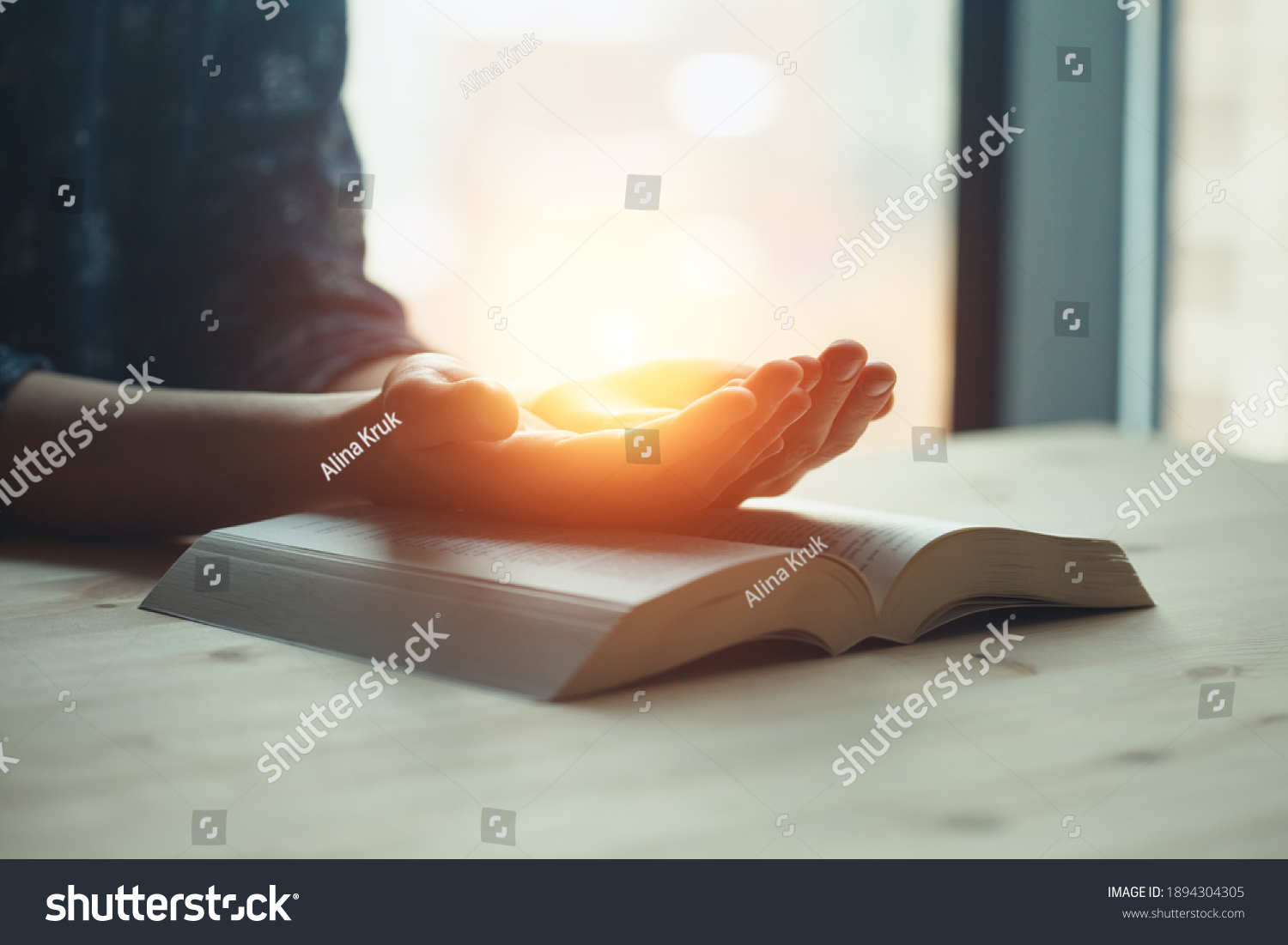 praying hands, young woman prayer  with hands together over a Holy Bible, spiritual light, mind and soul peace #1894304305