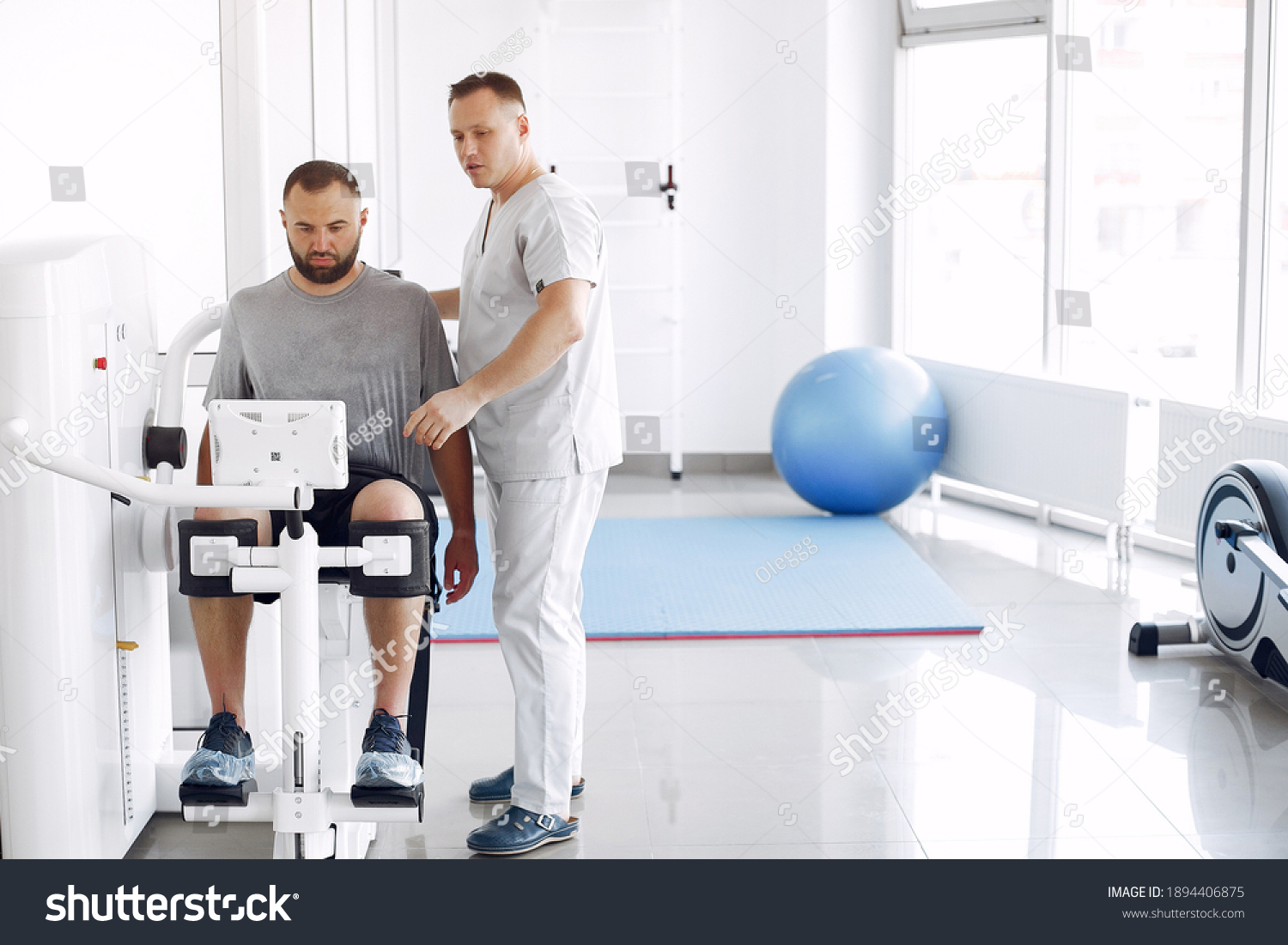 Patient has a rehabilitation in physiotherapy clinic. Doctor in a uniform. #1894406875