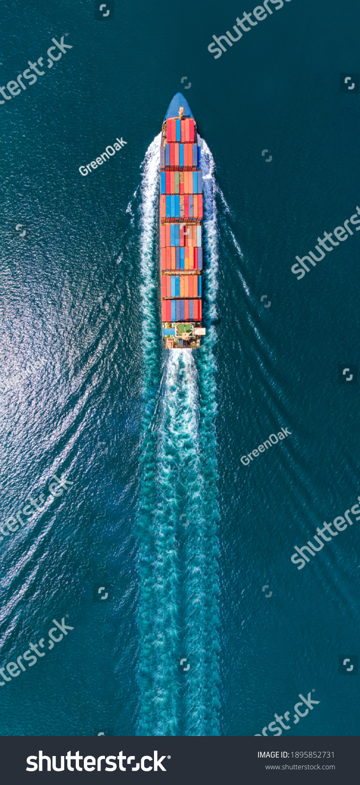 Aerial portrait view of smart cargo ship with contrail in the ocean sea ship carrying container from custom container depot go to ocean concept freight shipping by ship service. #1895852731