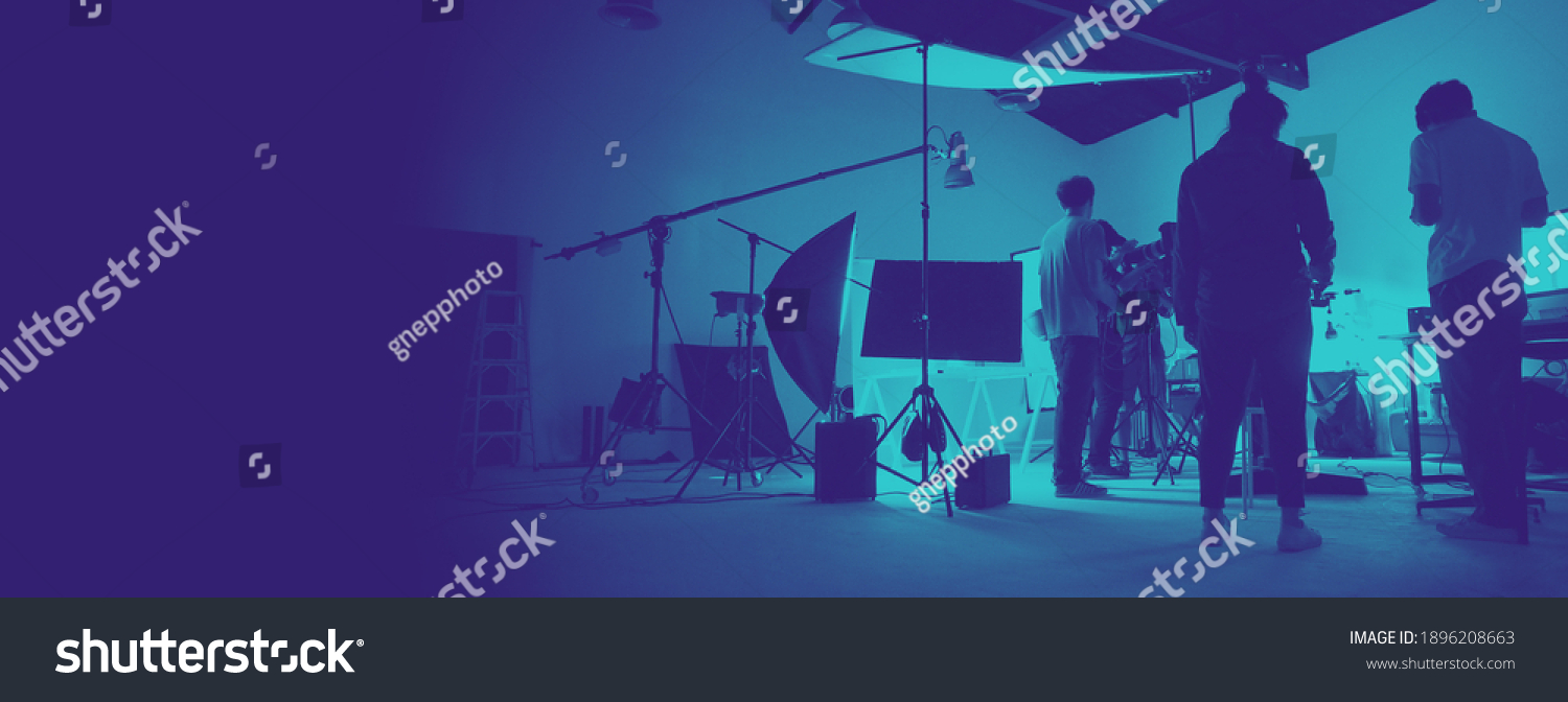 Two tone images of behind the scene of photo shooting production set up in the big studio. Professional crew team working and camera equipment in silhouette. And copy space added. #1896208663