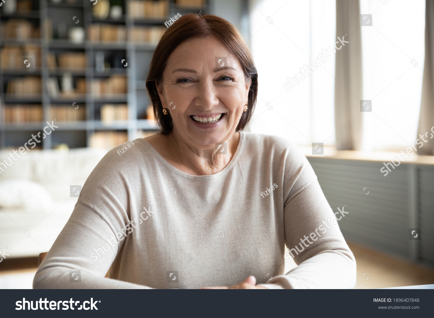 Head shot portrait smiling mature woman making video call, grandmother chatting with relatives, using webcam, happy middle aged blogger recording vlog, teacher holding online lesson, distance lecture #1896407848