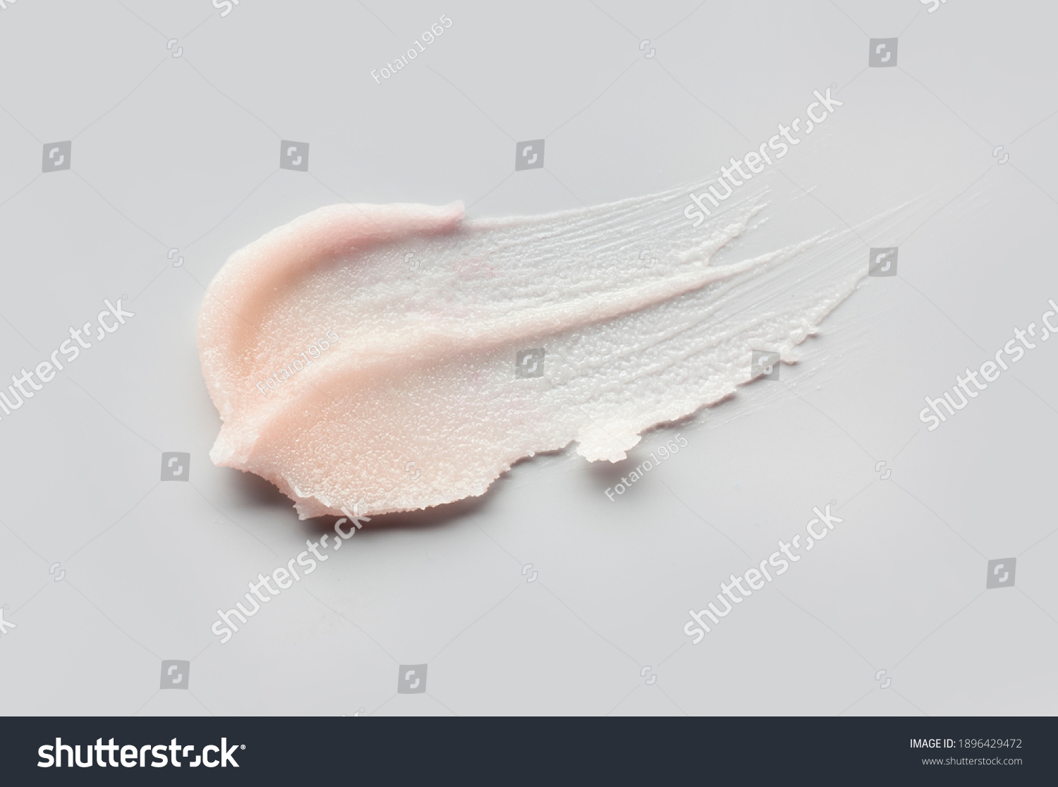 Cosmetic lip balm, salt or sugar scrub swatch on gray background #1896429472
