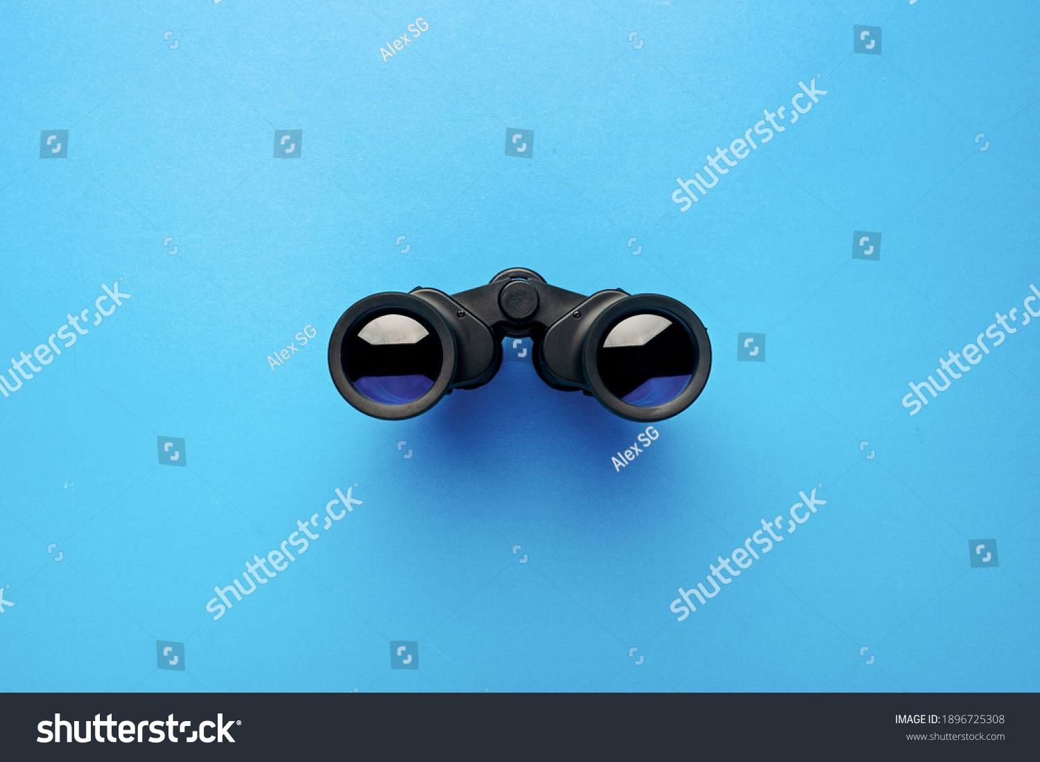 Binoculars on a light blue background. Banner. Flat lay, top view. #1896725308