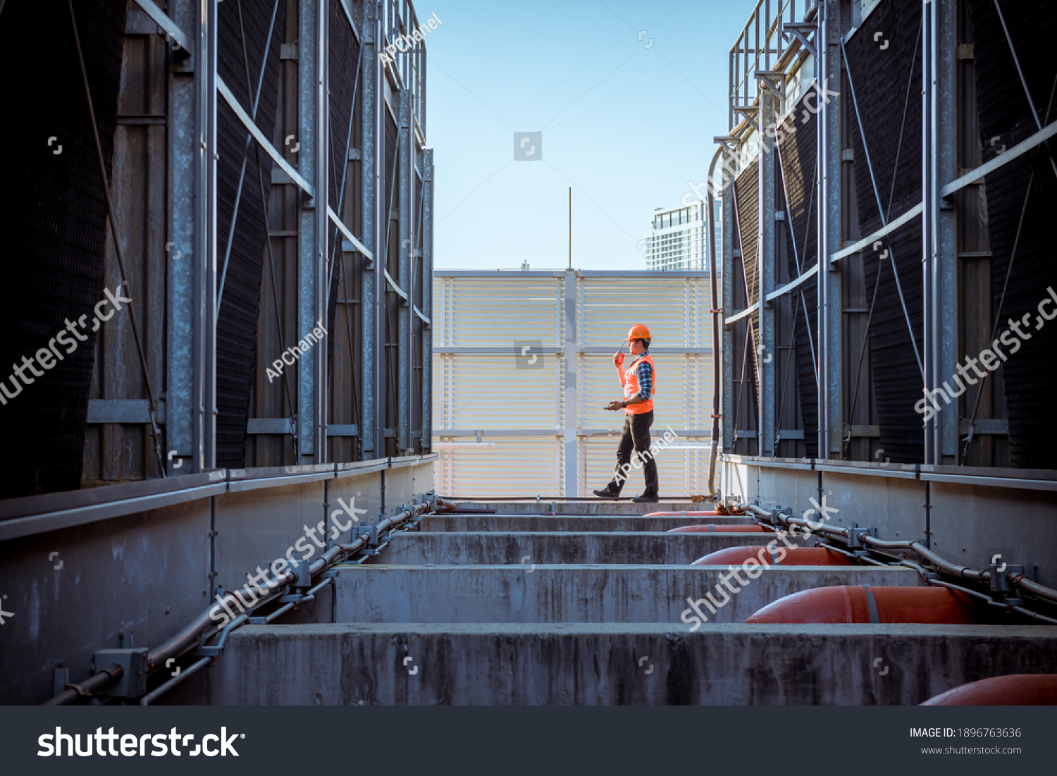 Engineer under checking the industry cooling tower air conditioner is water condenser cooling tower air chiller HVAC of large industrial building to control air system. #1896763636