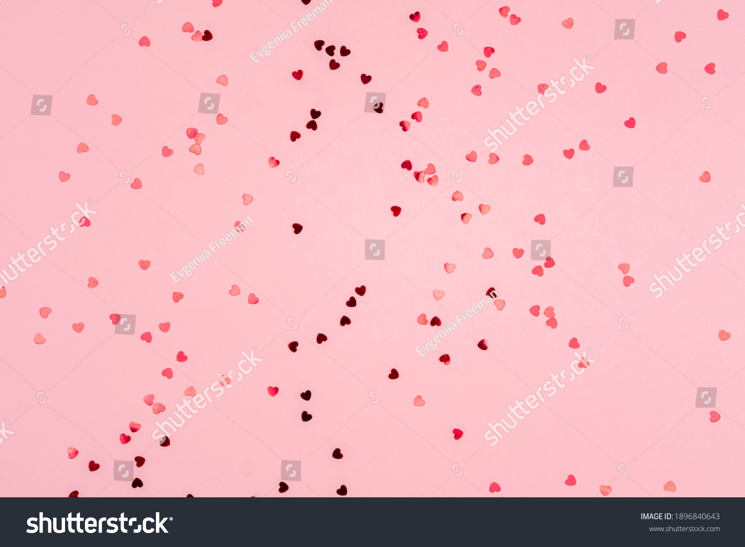 Pink background with glitter hearts for valentine's day. Beautiful wrapping paper or background for a postcard. Place for text, banner for website #1896840643