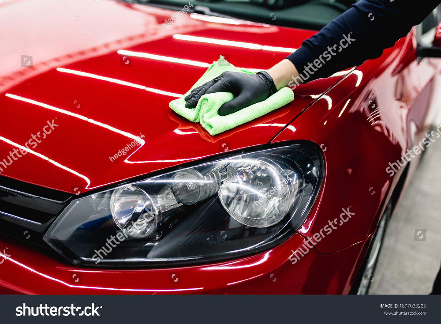 A man cleaning car with cloth, car detailing (or valeting) concept. Selective focus.  #1897033225