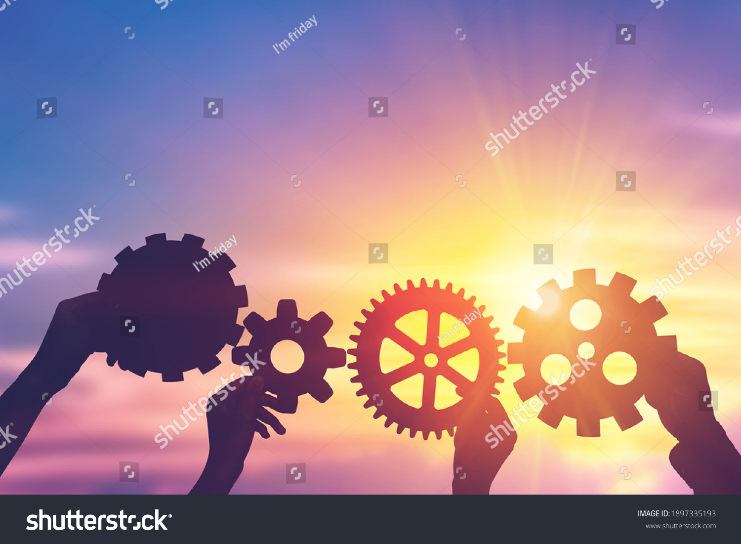 Silhouette hands holding gear from at sunlight background. concept of a teamwork cooperation idea.
 #1897335193
