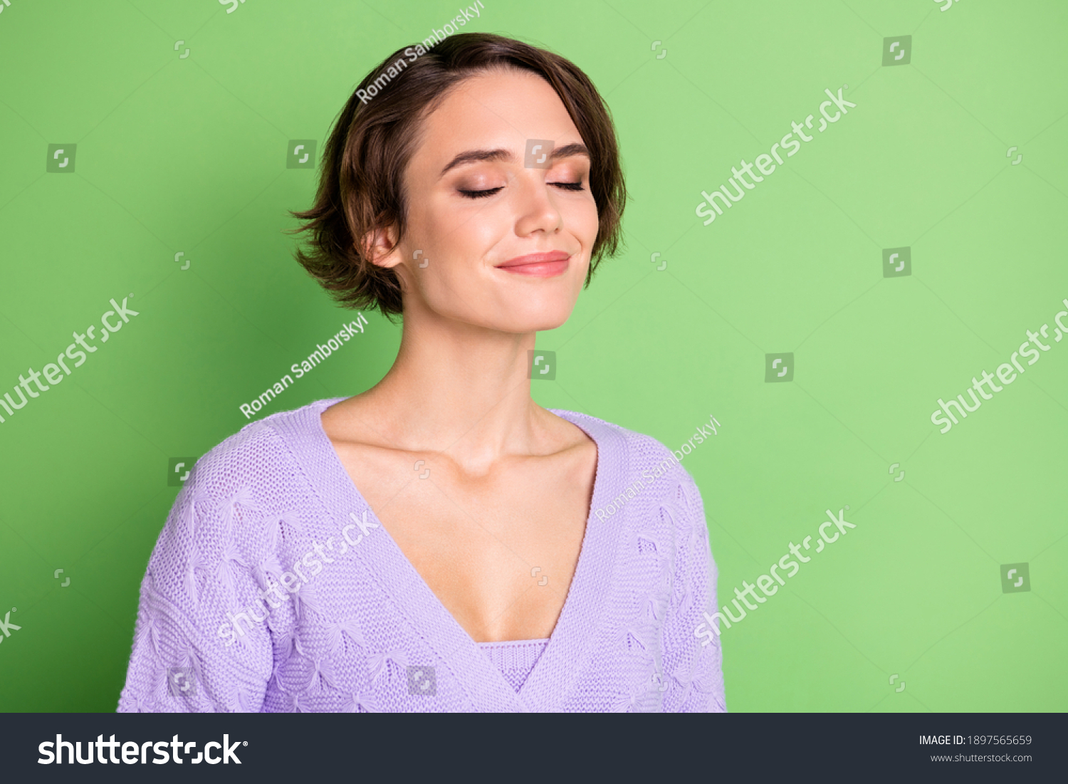 Portrait of adorable young girl closed eyes smile enjoying smell wear purple clothing isolated on green color background #1897565659
