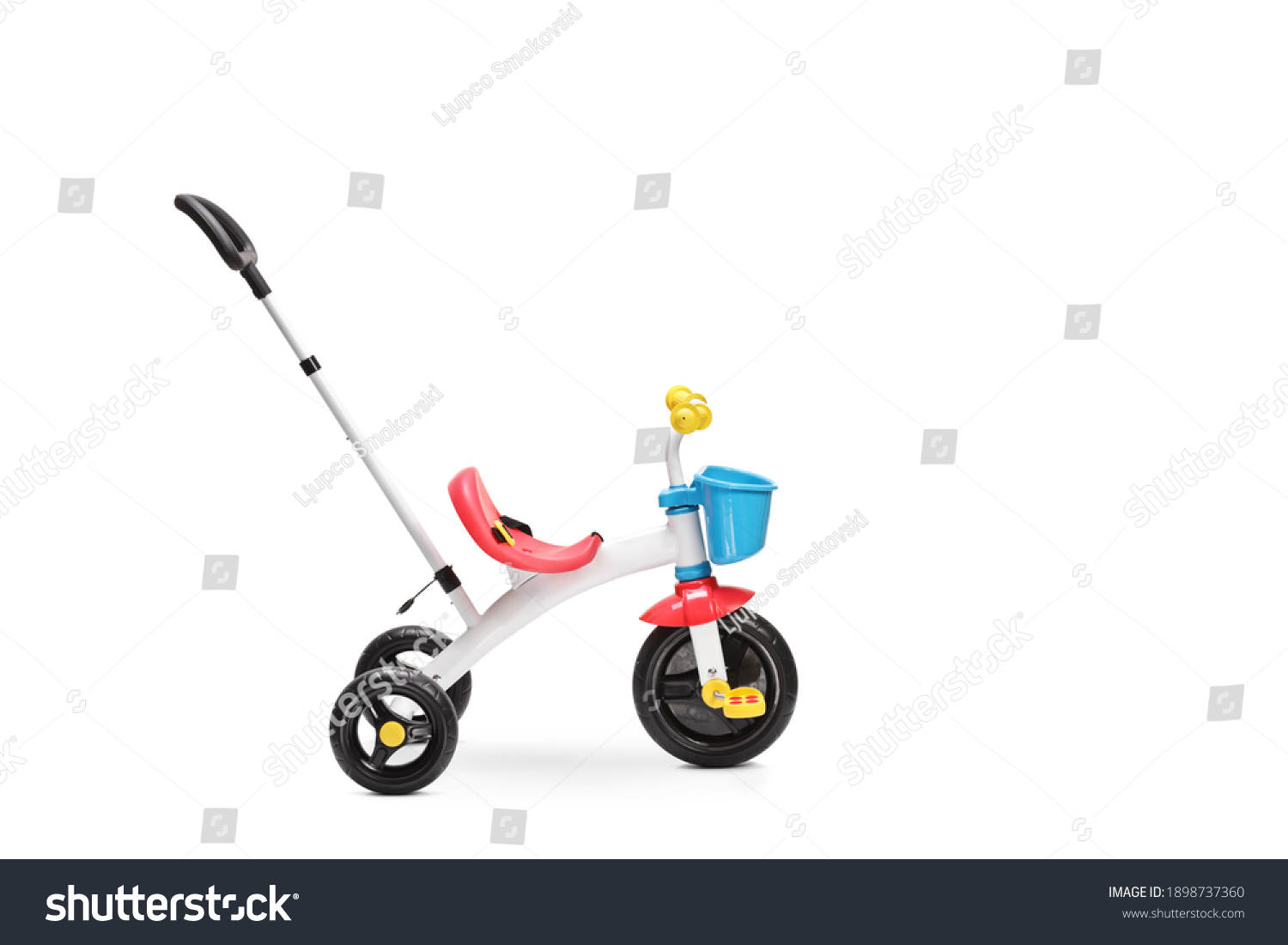 Studio shot of a tricycle for toddlers with a pushing handle isolated on white background #1898737360