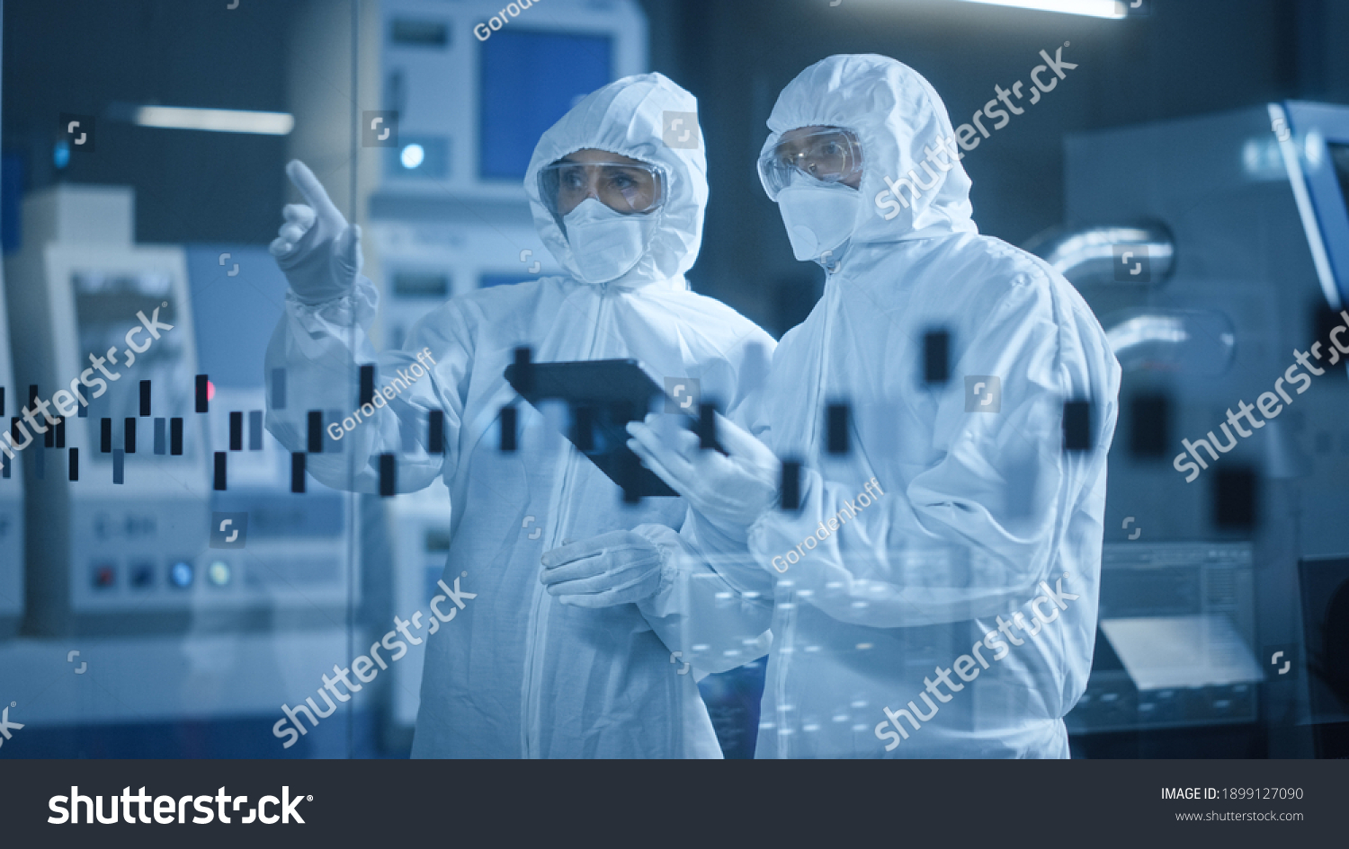 Factory Cleanroom: Engineer and Scientist Wearing Coveralls, Standing in Workshop Talk and Use Tablet Computer, Professionals Develop Technology for Modern CNC Machinery and Electronic Equipment #1899127090