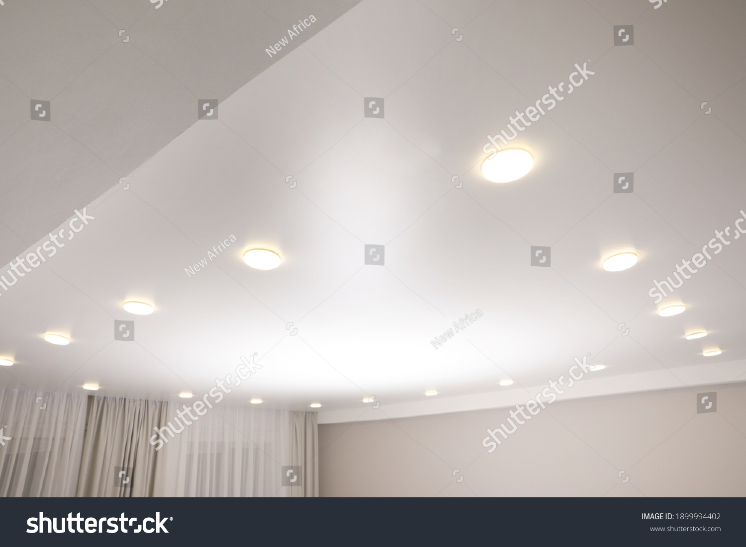 White stretch ceiling with spot lights in room #1899994402