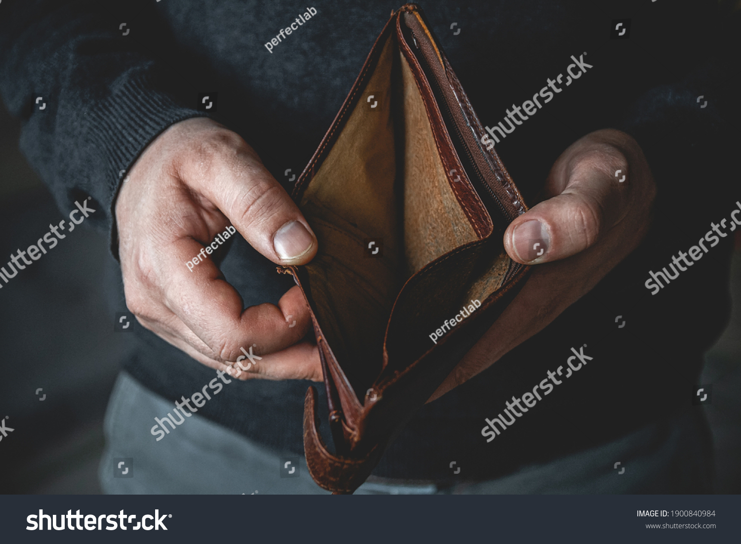 An Empty wallet in the hands of a young man #1900840984