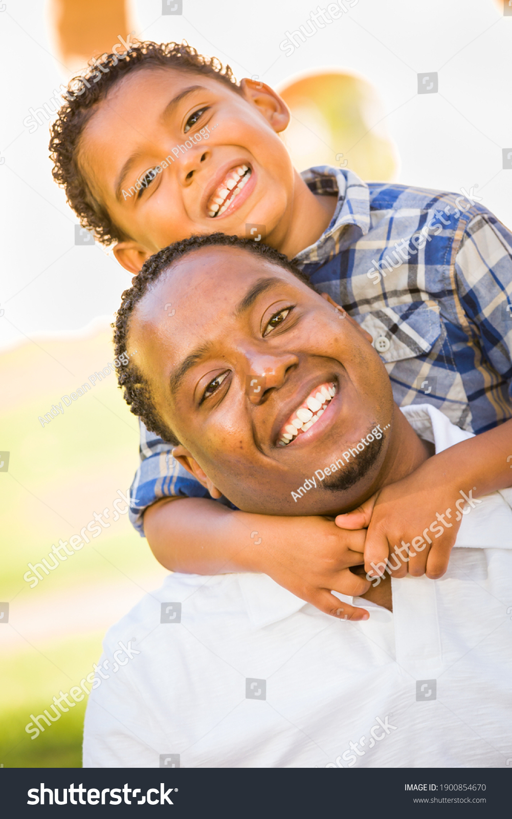 Happy African American Father and Mixed Race Son Playing At The Park. #1900854670