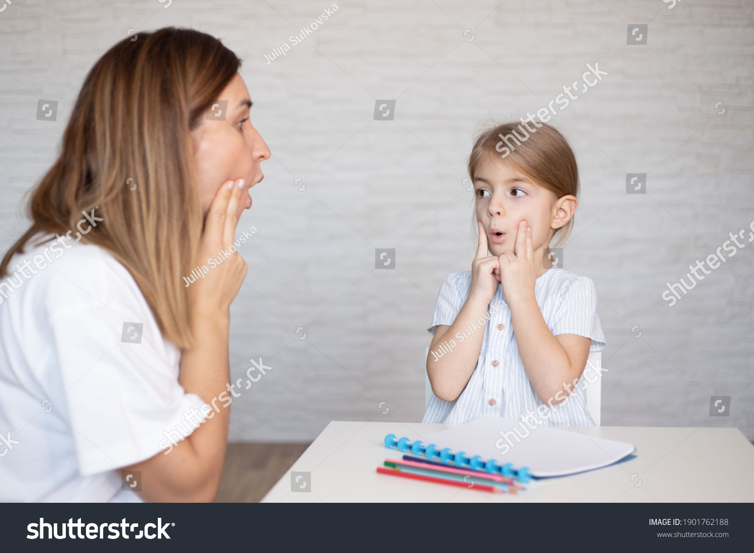 Young women with child make speech therapy exercises at home. #1901762188
