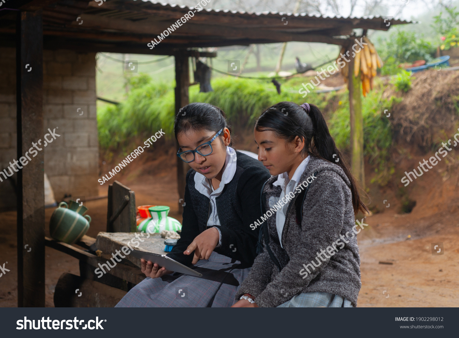 Girls students doing their homework with a digital tablet at home. #1902298012