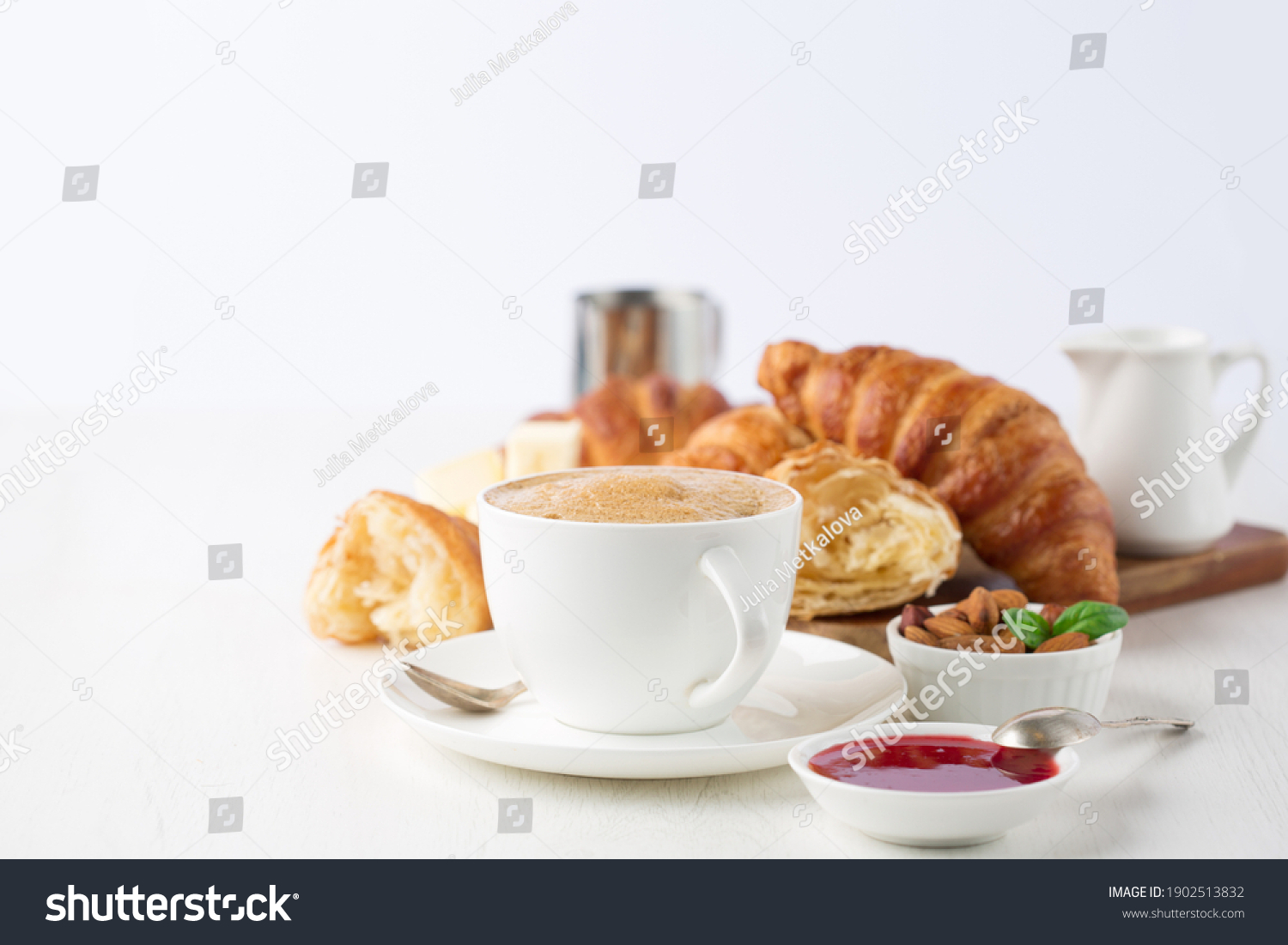 Fresh delicious breakfast with Coffee, crispy croissants, jam on white wooden background. Selective focus. Romantic french weekend concept. Copy space. #1902513832