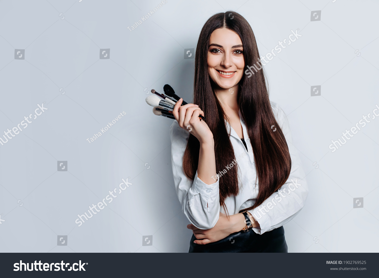 Makeup artist with brushes in hand on a white background #1902769525