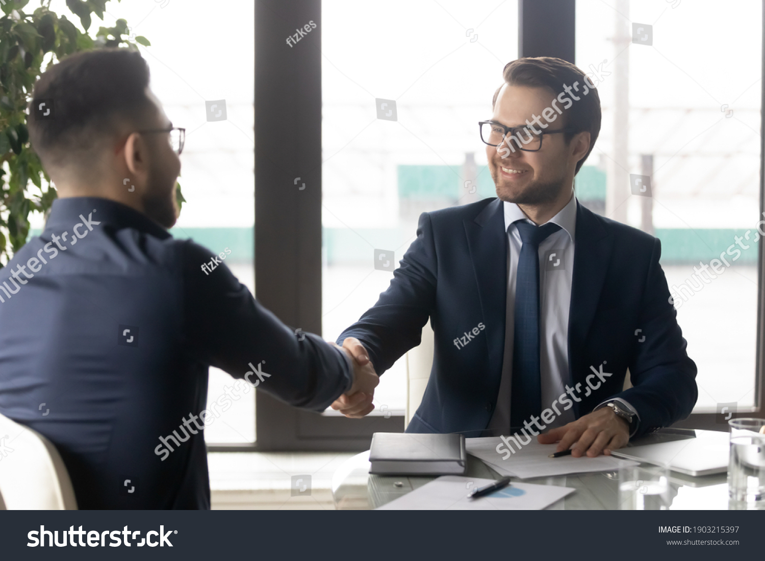 Smiling hr manager shaking hand of successful candidate after interview, Arabian man getting job, diverse business partners handshake, making great deal, agreement, employer greeting new employee #1903215397