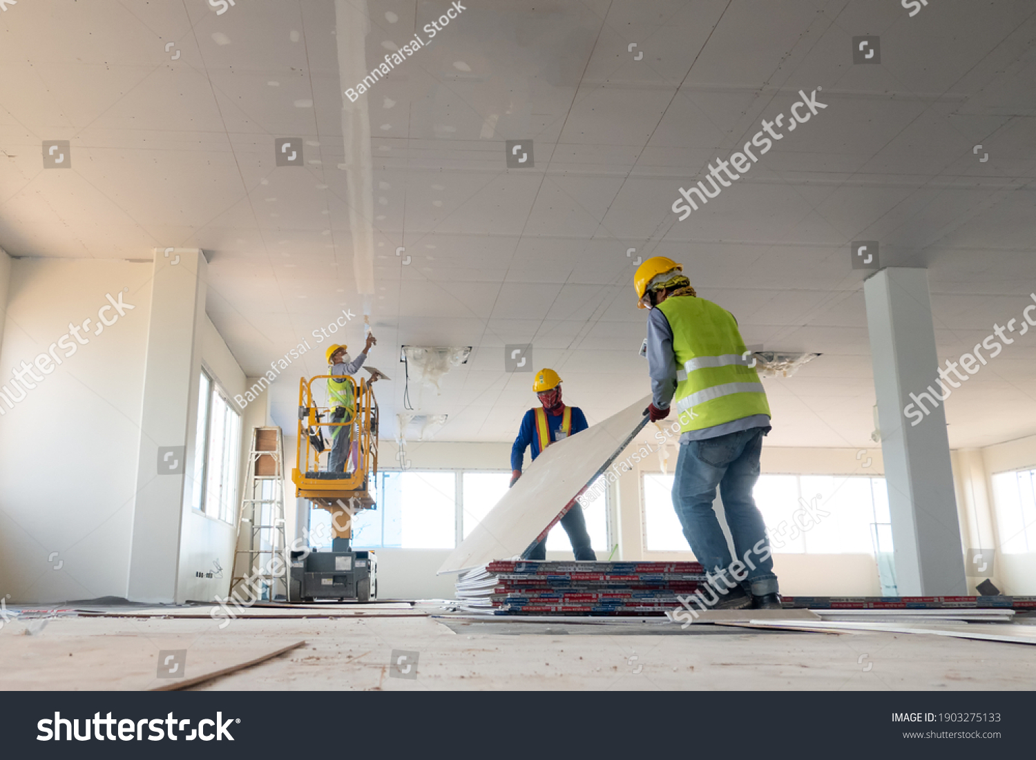 Construction worker installation ceiling work #1903275133