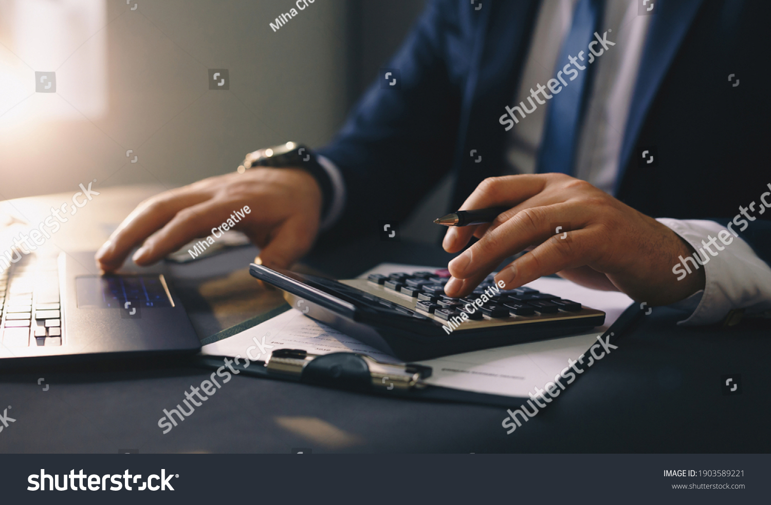 Businessman calculating the financial statement of his business. Accounting and Tax. #1903589221