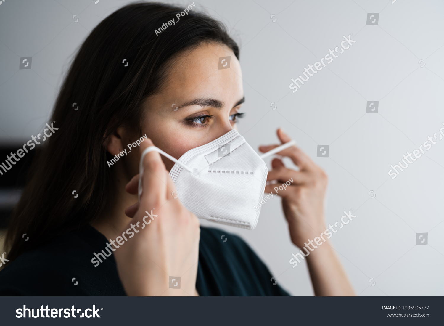 Woman Putting On Medical N95 Face Mask #1905906772