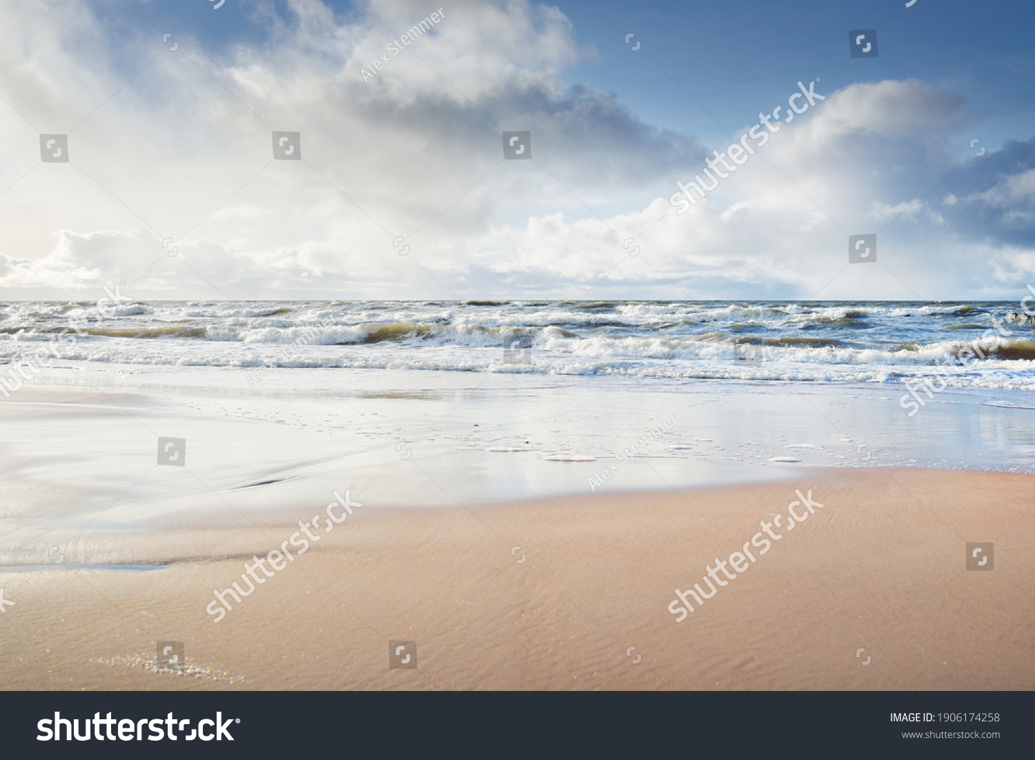 Panoramic view of Baltic sea from sandy shore (sand dunes). Dramatic sky with glowing clouds, sunbeams. Waves, water splashes. Idyllic seascape. Warm winter weather, climate change, nature. Denmark #1906174258