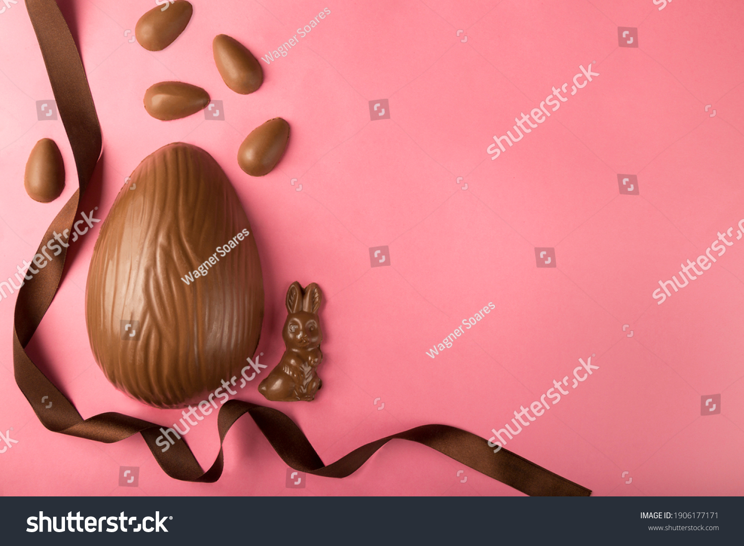 Easter. Composition with chocolate Easter eggs on pink background, space for text. #1906177171