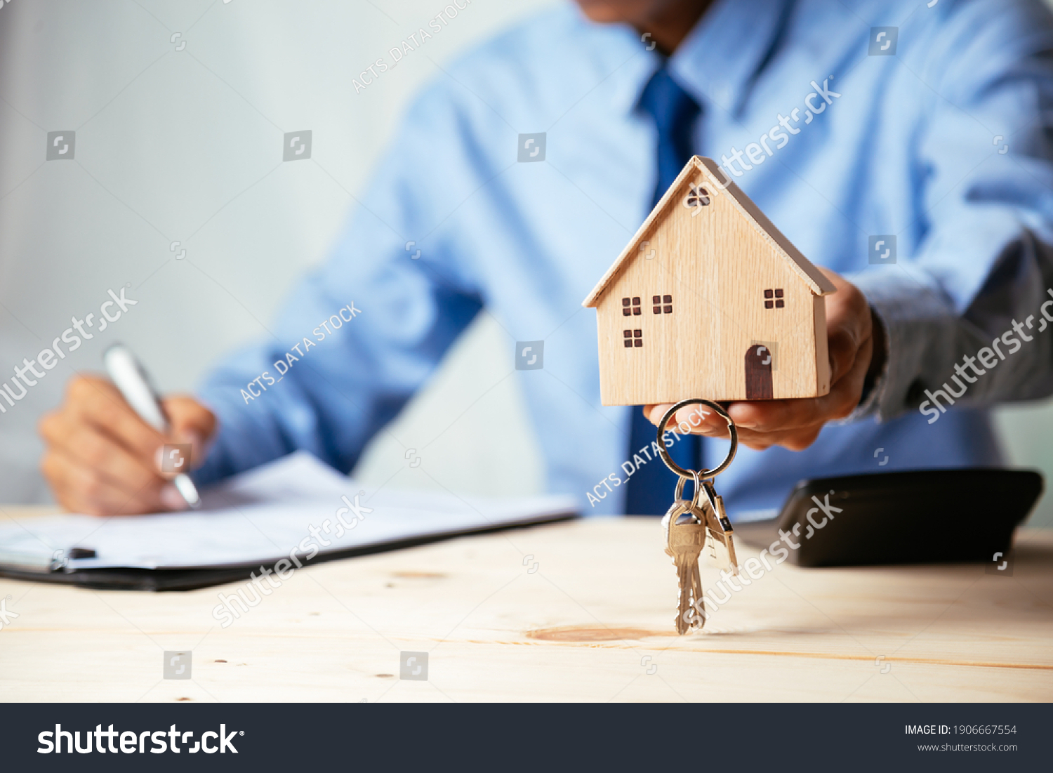 House model with real estate agent and customer discussing for contract to buy house, insurance or loan real estate,real estate concept. #1906667554