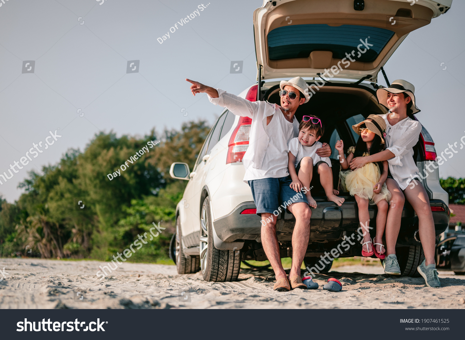 Happy asian family enjoying road trip with their favorite car. Parents and children are traveling the way to the sea or ocean.Holiday and travel family concept, Summer vacations. #1907461525