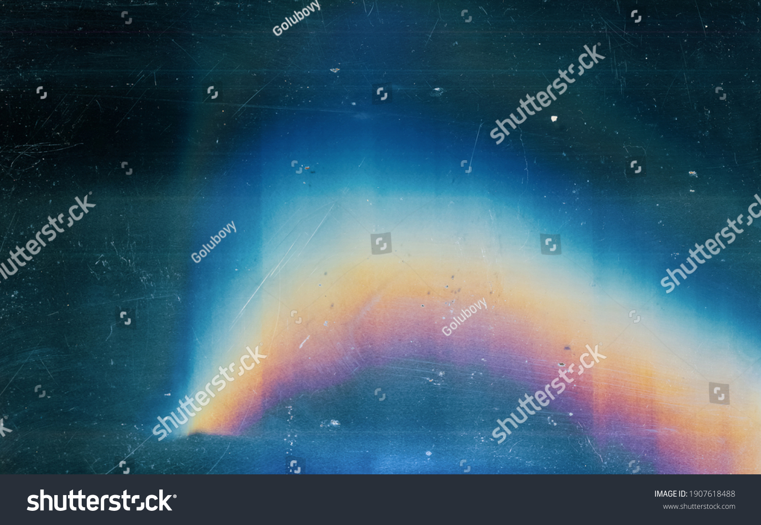 Distressed background. Colorful lens flare. Blue weathered faded stained glass with dust scratches texture smeared dirt blur rainbow light effect. #1907618488