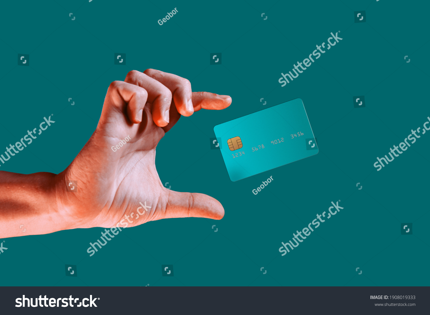Close up male hand and levitating template mockup bank credit card with online service isolated on green background #1908019333