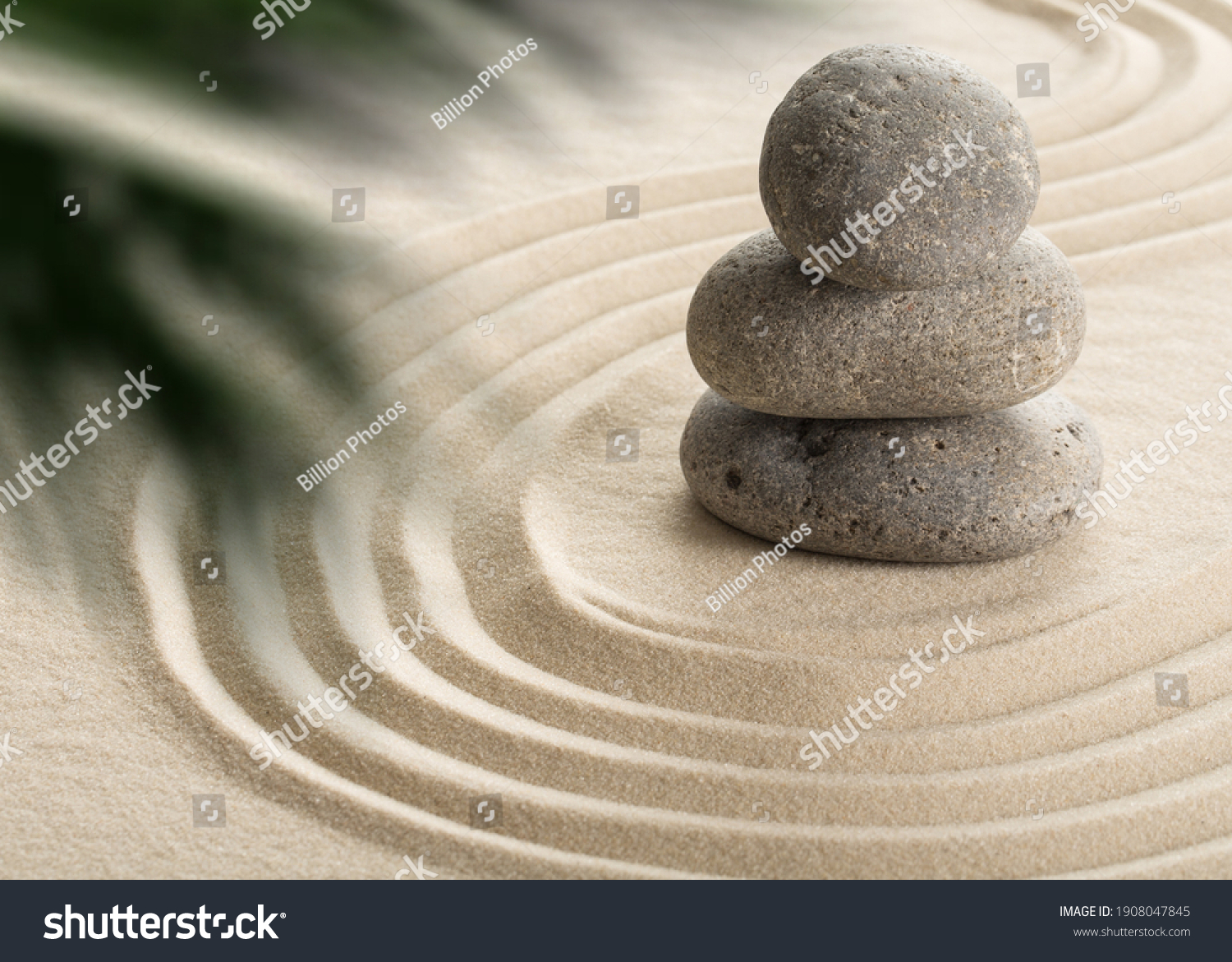 Pyramids of gray zen stones on the white sand with abstract wave drawings. Concept of harmony, balance and meditation, spa, massage, relax. #1908047845