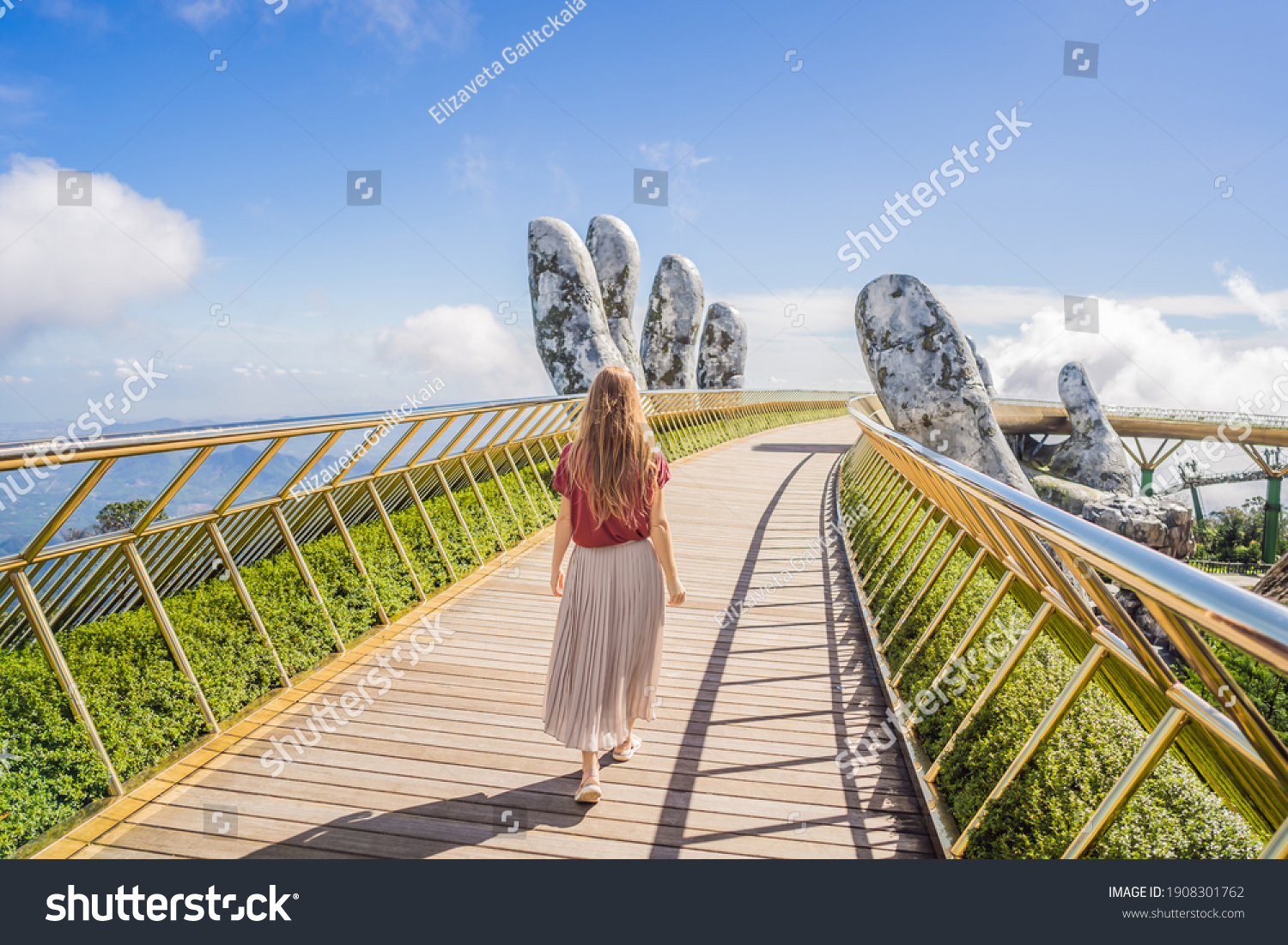 Young woman tourist at Famous tourist attraction - Golden bridge at the top of the Ba Na Hills, Vietnam #1908301762